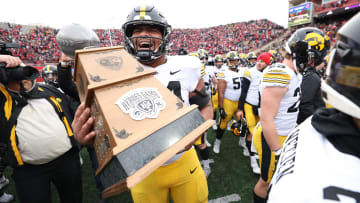 Nov 24, 2023; Lincoln, Nebraska, USA; Iowa Hawkeyes defensive lineman Yahya Black (94) carries the Heroes Trophy after beating the Nebraska Cornhuskers at Memorial Stadium. Mandatory Credit: Reese Strickland-USA TODAY Sports