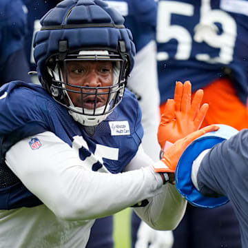 DeMarcus Walker goes through drills in Bears training camp. The defensive end sat out Wednesday's practice with a foot injury.