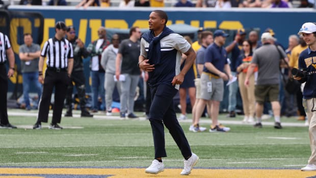Former West Virginia University quarterback Pat White runs across the field during the 2024 Gold-Blue Spring Game.