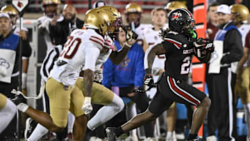 Oct 25, 2025; Louisville, Kentucky, USA;  Louisville Cardinals running back Keyjuan Brown (22) runs the ball against the Boston College Eagles during the first half at L&N Federal Credit Union Stadium. Louisville defeated Boston College 38-24. Mandatory Credit: Jamie Rhodes-Imagn Images