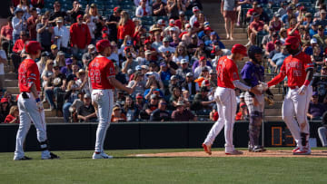 Mar 8, 2024; Tempe, Arizona, USA; Los Angeles Angels designated hitter Miguel Sano (22) comes in to score after hitting a home run in the seventh and celebrates with outfielder Logan O’Hoppe (14), infielder Brandon Drury (23) and infielder Cole Fontenelle (76) during a spring training game against the Colorado Rockies at Tempe Diablo Stadium. Mandatory Credit: Allan Henry-USA TODAY Sports