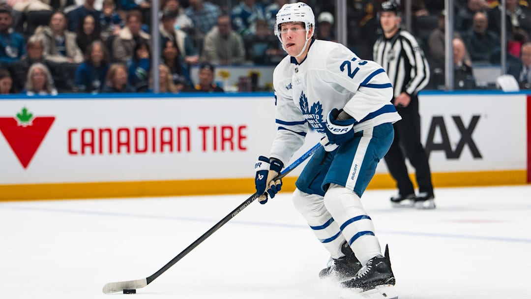 Jan 31, 2026; Vancouver, British Columbia, CAN; Toronto Maple Leafs defenseman Brandon Carlo (25) handles the puck against the Vancouver Canucks in the first period at Rogers Arena. Mandatory Credit: Bob Frid-Imagn Images