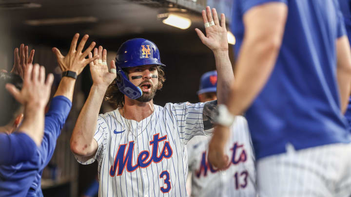 Aug 14, 2024; New York City, New York, USA;  New York Mets left fielder Jesse Winker (3) celebrates in the dugout with his teammates after scoring in the second inning against the Oakland Athletics at Citi Field.