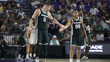 Nov 25, 2025; Fort Myers, Florida, USA; Michigan State Spartans forward Jaxon Kohler (0) and guard Divine Ugochukwu (99) react after a three point basket against the East Carolina Pirates in the second half at Suncoast Credit Union Arena. Mandatory Credit: Nathan Ray Seebeck-Imagn Images
