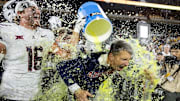 Nov 28, 2025; Tempe, Arizona, USA; Arizona Wildcats head coach Brent Brennan is doused with Powerade after defeating the Arizona State Sun Devils during the 99th Territorial Cup at Mountain America Stadium. Mandatory Credit: Mark J. Rebilas-Imagn Images