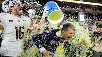 Nov 28, 2025; Tempe, Arizona, USA; Arizona Wildcats head coach Brent Brennan is doused with Powerade after defeating the Arizona State Sun Devils during the 99th Territorial Cup at Mountain America Stadium. Mandatory Credit: Mark J. Rebilas-Imagn Images