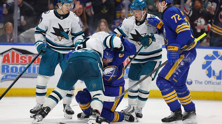 Buffalo Sabres winger Zach Benson surrounded by three players from the San Jose Sharks