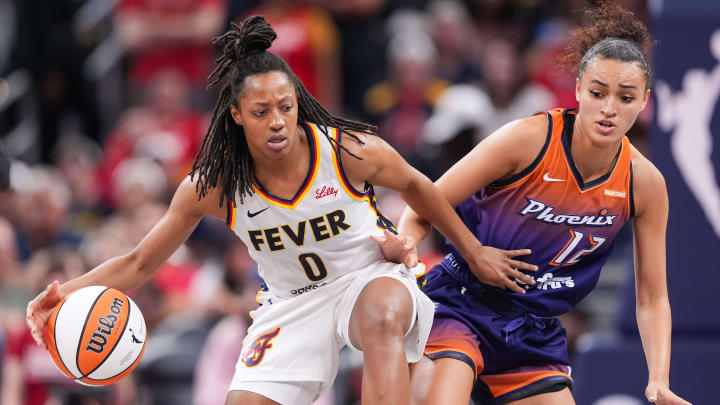 Indiana Fever guard Kelsey Mitchell (0) rushes up the court against Phoenix Mercury Celeste Taylor (12) 