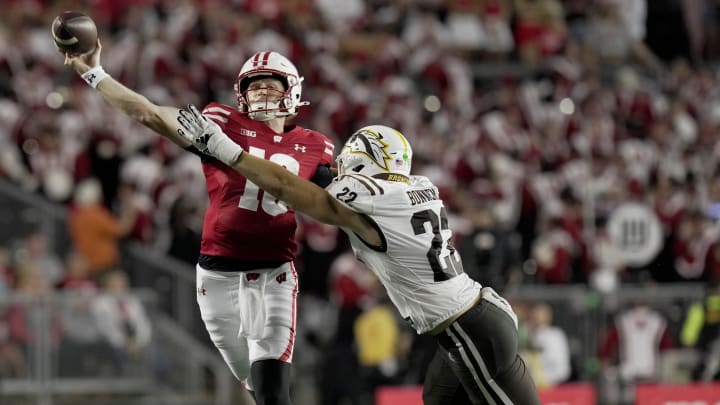 Wisconsin quarterback Tyler Van Dyke (10) is pressured by Western Michigan linebacker Boone Bonnema (22) during the third quarter of their game Friday, Aug. 30, 2024, at Camp Randall Stadium in Madison, Wis.