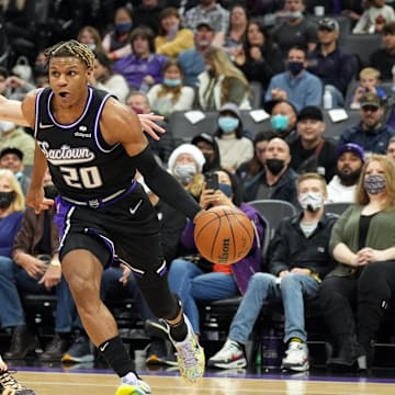 Dec 19, 2021; Sacramento, California, USA; Sacramento Kings guard Jahmi'us Ramsey (20) dribbles past San Antonio Spurs forward Drew Eubanks (14) during the third quarter at Golden 1 Center. Mandatory Credit: Darren Yamashita-Imagn Images