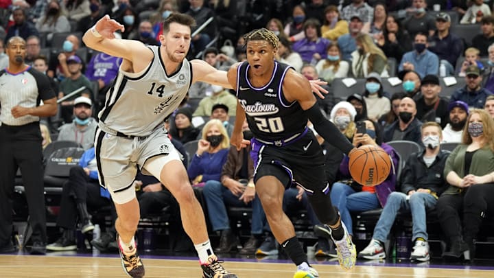 Dec 19, 2021; Sacramento, California, USA; Sacramento Kings guard Jahmi'us Ramsey (20) dribbles past San Antonio Spurs forward Drew Eubanks (14) during the third quarter at Golden 1 Center. Mandatory Credit: Darren Yamashita-Imagn Images