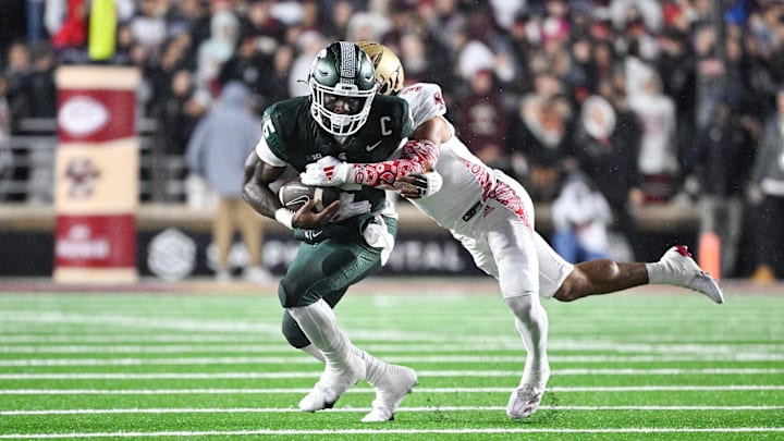 Sep 21, 2024; Chestnut Hill, Massachusetts, USA; Michigan State Spartans running back Nate Carter (5) runs the ball with Michigan State Spartans defensive back Jeremiah Hughes (3) tackling during the first half at Alumni Stadium. Mandatory Credit: Eric Canha-Imagn Images