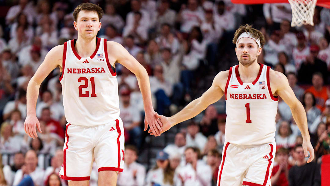 Pryce Sandfort and Sam Hoiberg celebrate after a three-point shot against the Illinois Fighting Illini.