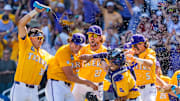 The LSU Tigers celebrate after defeating the Coastal Carolina Chanticleers to win the championship at Charles Schwab Field. 