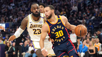 Jan 25, 2025; San Francisco, California, USA; Golden State Warriors guard Stephen Curry (30) dribbles against Los Angeles Lakers forward LeBron James (23) during the third quarter at Chase Center. Mandatory Credit: Darren Yamashita-Imagn Images