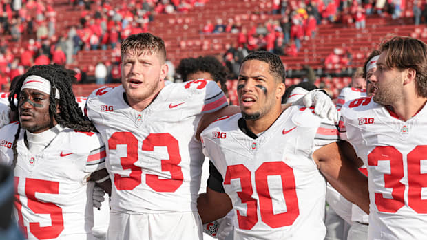 Ohio State Buckeyes defensive end Jack Sawyer (33) and linebacker Cody Simon (30)