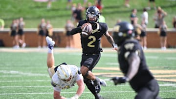 Sep 27, 2025; Winston-Salem, North Carolina, USA;  Georgia Tech Yellow Jackets defensive lineman Jordan van den Berg (99) attempts to tackle Wake Forest Demon Deacons quarterback Robby Ashford (2) during the fourth quarter at Allegacy Federal Credit Union Stadium. Mandatory Credit: Zachary Taft-Imagn Images