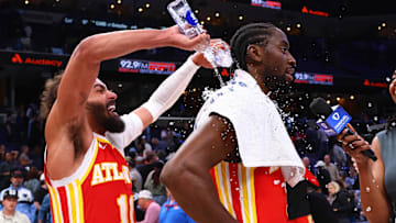 Mar 3, 2025; Memphis, Tennessee, USA; Atlanta Hawks guard Trae Young (11) dumps water on guard Caris LeVert (3) after defeating the Memphis Grizzlies at FedExForum. Mandatory Credit: Petre Thomas-Imagn Images