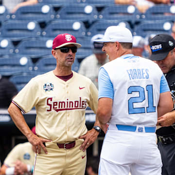 Jun 18, 2024; Omaha, NE, USA; Florida State Seminoles head coach Link Jarrett and North Carolina Tar Heels head coach Scott Forbes talk before the game at Charles Schwab Field Omaha. Mandatory Credit: Dylan Widger-Imagn Images