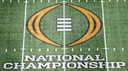 The College Football Playoff National Championship logo at midfield at Mercedes-Benz Stadium, the site of the 2025 national championship between the Ohio State Buckeyes and the Notre Dame Fighting Irish.