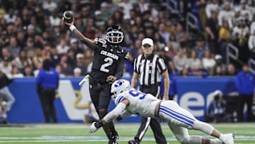 Dec 28, 2024; San Antonio, TX, USA; Colorado Buffaloes quarterback Shedeur Sanders (2) attempts a pass as Brigham Young Cougars defensive end Tyler Batty (92) attempts to make a tackle during the third quarter at Alamodome. 