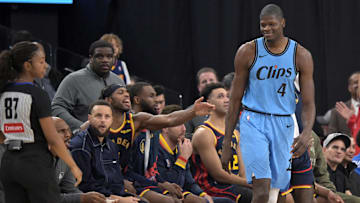 Dec 27, 2024; Inglewood, California, USA; Los Angeles Clippers center Mo Bamba (4) smiles at the Golden State Warriors bench after blocking a shot in the first half at Intuit Dome. Mandatory Credit: Jayne Kamin-Oncea-Imagn Images