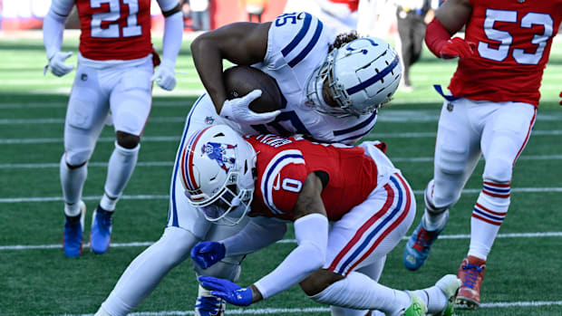 Dec 1, 2024; Foxborough, Massachusetts, USA; New England Patriots cornerback Christian Gonzalez (0) tackles Indianapolis Colt