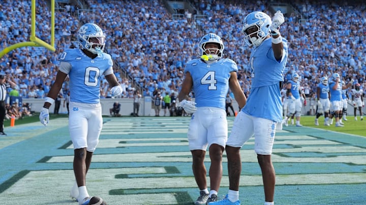 Sep 13, 2025; Chapel Hill, North Carolina, USA; North Carolina Tar Heels wide receiver Jordan Shipp (1) celebrates with wide receiver Alex Taylor (0) and running back Caleb Hood (4) after making a touchdown catch in the third quarter at Kenan Stadium. Mandatory Credit: Bob Donnan-Imagn Images