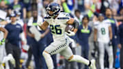 Dec 8, 2024; Glendale, Arizona, USA; Seattle Seahawks running back Zach Charbonnet (26) runs for a touchdown against the Arizona Cardinals in the first half at State Farm Stadium. Mandatory Credit: Mark J. Rebilas-Imagn Images