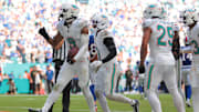 Nov 9, 2025; Miami Gardens, Florida, USA; Miami Dolphins safety Ifeatu Melifonwu (9) celebrates with safety Dante Trader Jr. (11) and safety Minkah Fitzpatrick (29) after an interception against the Buffalo Bills during the second half at Hard Rock Stadium. 