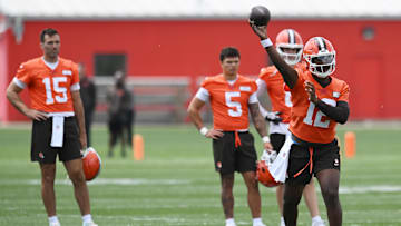 Jun 10, 2025; Berea, OH, USA; Cleveland Browns quarterback Shedeur Sanders (12) throws a pass as quarterback Joe Flacco (15) and quarterback Dillon Gabriel (5) and quarterback Kenny Pickett (8) look on during minicamp at CrossCountry Mortgage Campus. Mandatory Credit: Ken Blaze-Imagn Images