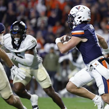 Nov 8, 2025; Charlottesville, Virginia, USA; Virginia Cavaliers quarterback Chandler Morris (4) runs with the ball and is injured on the play during the first half against the Wake Forest Demon Deacons at Scott Stadium. Mandatory Credit: Amber Searls-Imagn Images