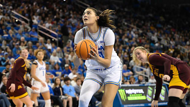 Feb 2, 2025; Los Angeles, California, USA; UCLA Bruins center Lauren Betts (51) drives to the basket past Minnesota Golden Go