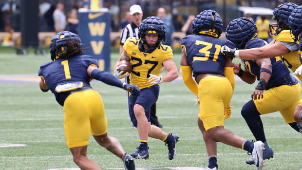 West Virginia University freshman running back Clay Ash searches for an opening during the Gold-Blue Spring Game.