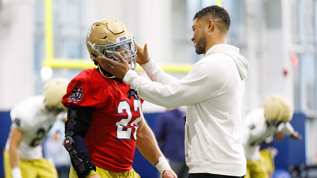 Head coach Marcus Freeman, right, taps running back Aneyas Williams on the helmet during a Notre Dame football practice at Irish Athletic Center on Friday, March 20, 2026, in South Bend. Head coach Marcus Freeman, right, taps running back Aneyas Williams on the helmet during a Notre Dame football practice at Irish Athletic Center on Friday, March 20, 2026, in South Bend.