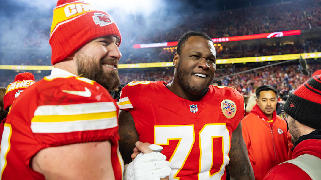 Jan 26, 2025; Kansas City, MO, USA; Kansas City Chiefs offensive tackle D.J. Humphries (70) and tight end Travis Kelce (87) celebrate after defeating the Buffalo Bills during the AFC Championship game at GEHA Field at Arrowhead Stadium. Mandatory Credit: Mark J. Rebilas-Imagn Images