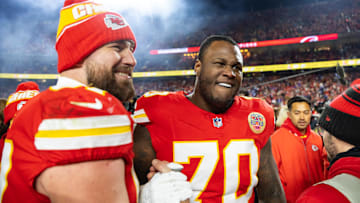 Jan 26, 2025; Kansas City, MO, USA; Kansas City Chiefs offensive tackle D.J. Humphries (70) and tight end Travis Kelce (87) celebrate after defeating the Buffalo Bills during the AFC Championship game at GEHA Field at Arrowhead Stadium. Mandatory Credit: Mark J. Rebilas-Imagn Images