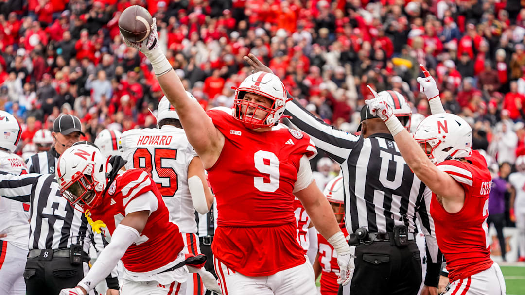 Nov 11, 2023; Lincoln, Nebraska, USA; Nebraska Cornhuskers defensive lineman Ty Robinson (9), linebacker Luke Reimer (4), and defensive back Isaac Gifford (2) celebrate after recovering a fumble against the Maryland Terrapins during the fourth quarter at Memorial Stadium. Mandatory Credit: Dylan Widger-Imagn Images