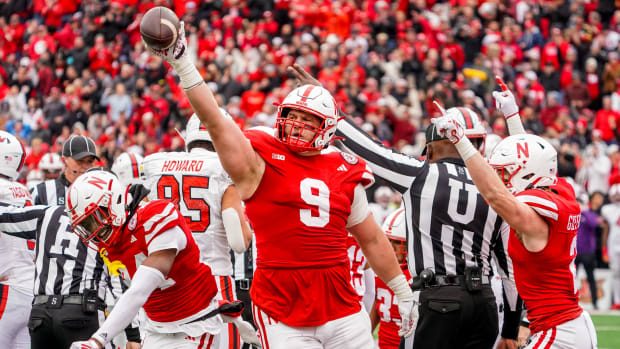 Nebraska Cornhuskers defensive lineman Ty Robinson (9), linebacker Luke Reimer (4), and defensive back Isaac Gifford (2)