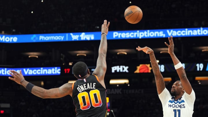 Apr 28, 2024; Phoenix, Arizona, USA; Minnesota Timberwolves center Naz Reid (11) shoots over Phoenix Suns forward Royce O'Neale (00) during the first half of game four of the first round for the 2024 NBA playoffs at Footprint Center. Mandatory Credit: Joe Camporeale-USA TODAY Sports