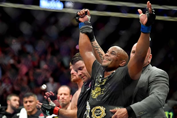 Daniel Cormier (blue gloves) celebrates beating Stipe Miocic (red gloves) during UFC 226 at T-Mobile Arena. 