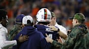 Nov 8, 2025; Charlottesville, Virginia, USA; Virginia Cavaliers quarterback Chandler Morris (4) is escorted off the field by medical staff after being injured against the Wake Forest Demon Deacons during the first half at Scott Stadium. Mandatory Credit: Amber Searls-Imagn Images