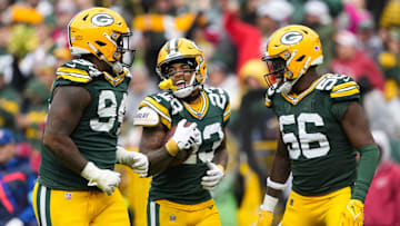 Oct 13, 2024; Green Bay, Wisconsin, USA;  Green Bay Packers cornerback Jaire Alexander (23) celebrates with defensive lineman Karl Brooks (94) and linebacker Edgerrin Cooper (56) after recovering a fumble during the third quarter against the Arizona Cardinals at Lambeau Field. Mandatory Credit: Jeff Hanisch-Imagn Images