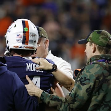 Nov 8, 2025; Charlottesville, Virginia, USA; Virginia Cavaliers quarterback Chandler Morris (4) is escorted off the field by medical staff after being injured against the Wake Forest Demon Deacons during the first half at Scott Stadium. Mandatory Credit: Amber Searls-Imagn Images