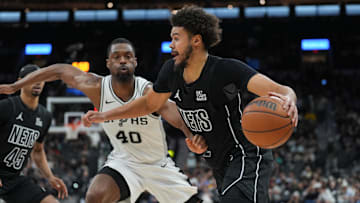Mar 4, 2025; San Antonio, Texas, USA;  Brooklyn Nets forward Cameron Johnson (2) dribbles past San Antonio Spurs forward Harrison Barnes (40) in the second half at Frost Bank Center. Mandatory Credit: Daniel Dunn-Imagn Images