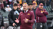 Nov 22, 2025; Chicago, Illinois, USA; Minnesota Golden Gophers head coach P.J. Fleck directs his team against the Northwestern Wildcats during the first half at Wrigley Field. Mandatory Credit: Patrick Gorski-Imagn Images