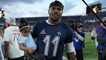 Feb 2, 2025; Orlando, FL, USA; NFC defensive end Micah Parson of the Dallas Cowboys (11) holds his daughter Shatara Parsons after the 2025 Pro Bowl Games at Camping World Stadium. Mandatory Credit: Kirby Lee-Imagn Images