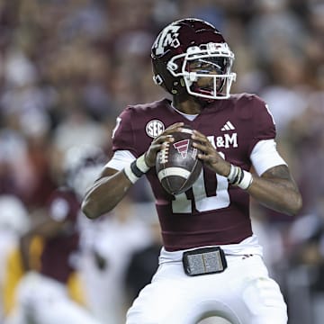 Nov 30, 2024; College Station, Texas, USA; Texas A&M Aggies quarterback Marcel Reed (10) looks for an open receiver during the second quarter against the Texas Longhorns at Kyle Field. Mandatory Credit: Troy Taormina-Imagn Images