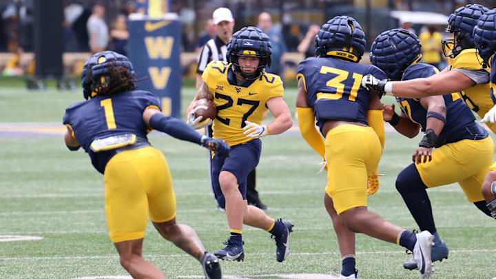 West Virginia University running back Clay Ash looks for space during the 2024 Gold-Blue Spring Game. West Virginia University running back Clay Ash looks for space during the 2024 Gold-Blue Spring Game.