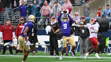 Sep 14, 2024; Seattle, Washington, USA; Washington Huskies cornerback Thaddeus Dixon (9) intercepts a pass intended by for Washington State Cougars wide receiver Kyle Williams (2) during the second half at Lumen Field. Mandatory Credit: Steven Bisig-Imagn Images